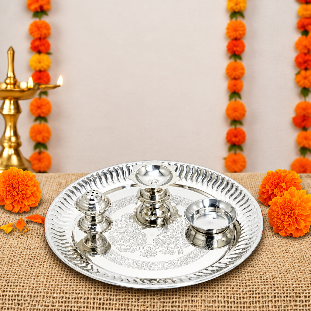 Stainless steel pooja thali displayed for aarti with small holders