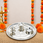 Stainless steel pooja thali displayed for aarti with small holders