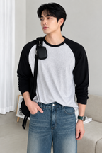HD front view of grey and black raglan full sleeve t-shirt with hand in pocket