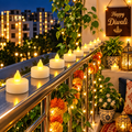 HD pack of 12 flameless LED tealight candles on a Diwali-decorated balcony railing