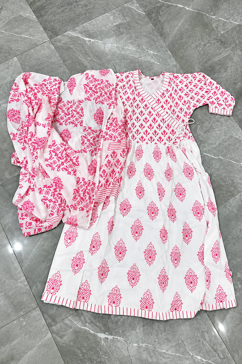 Pink kurti and dupatta laid flat