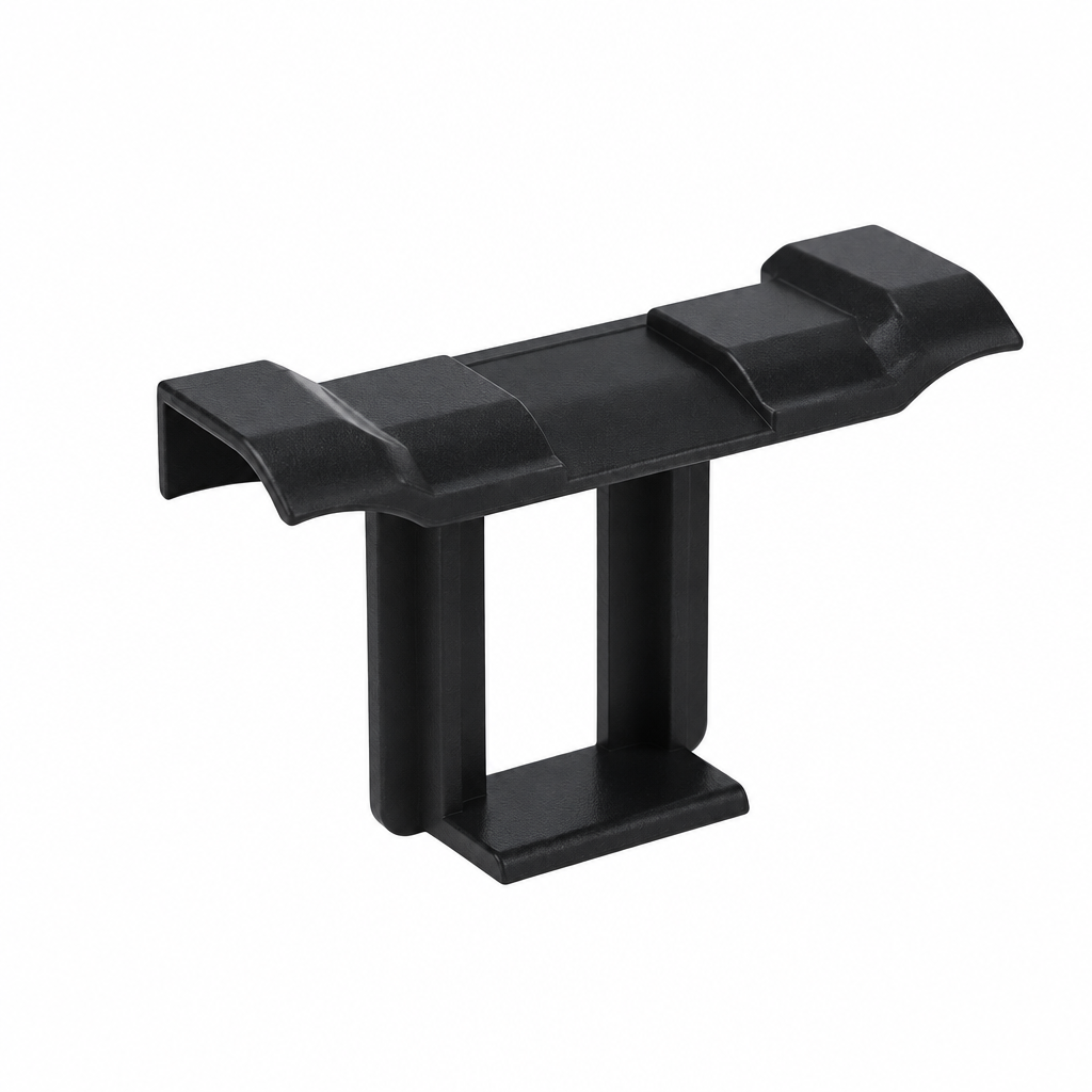Black solar panel water drainage clip with raised upper ridges and a rectangular lower opening on a white background