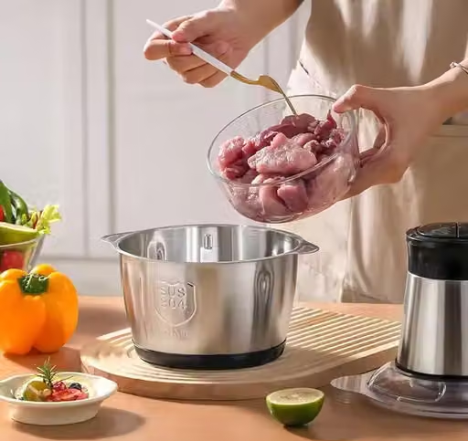 Stainless steel chopper bowl and motor on a kitchen counter