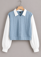 Front view of blue jacquard top with white collar and long white sleeves on a hanger