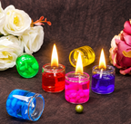 HD lit red, pink, purple and blue gel candles with flowers