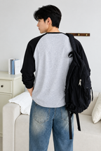 HD back view of grey and black raglan full sleeve t-shirt with black backpack