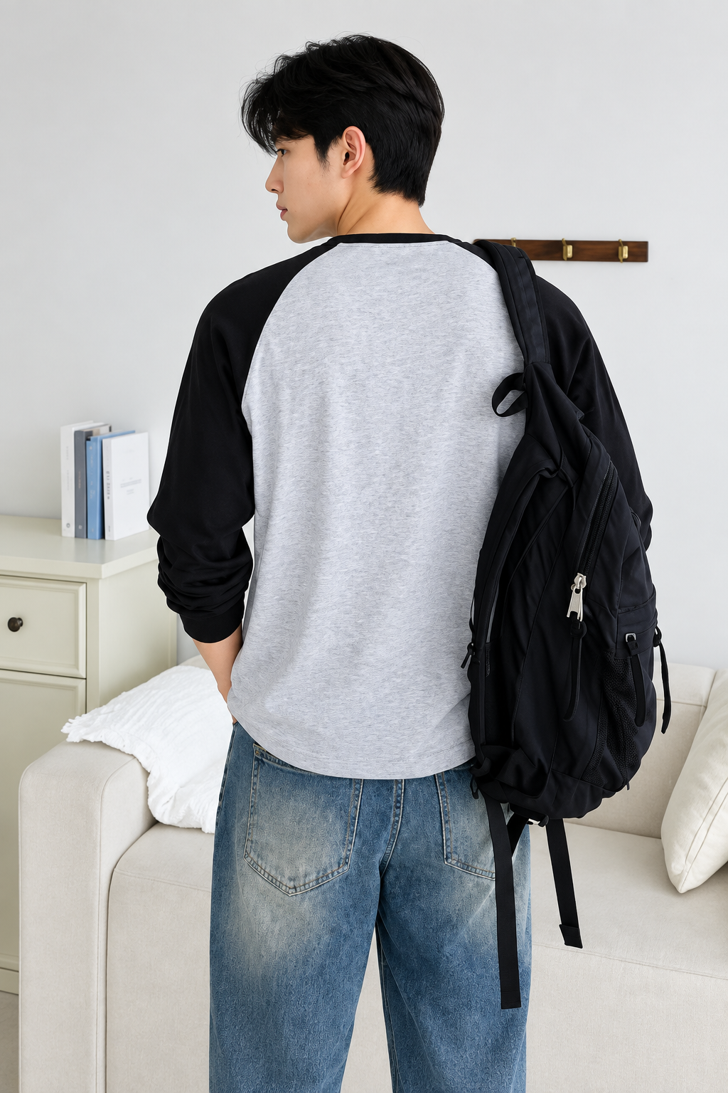 HD back view of grey and black raglan full sleeve t-shirt with black backpack