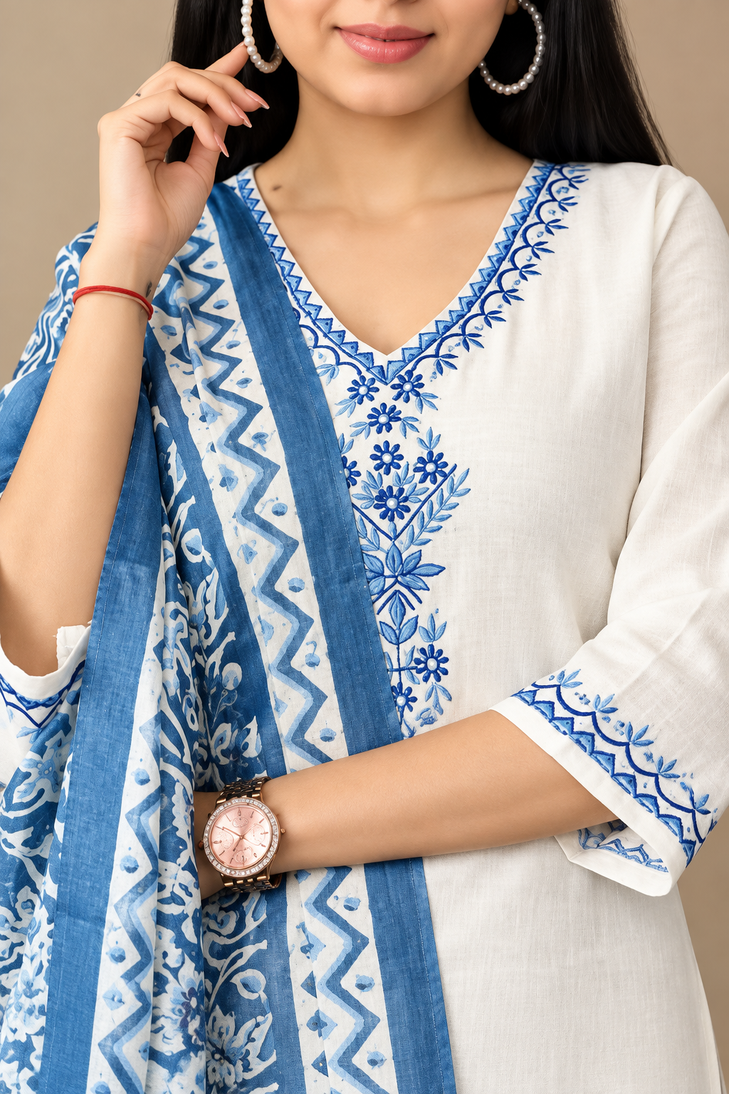 Close-up of cream kurta embroidery and aqua dupatta
