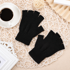 Two black knitted half-finger gloves with ribbed wrist cuffs on a light woven mat