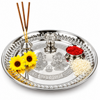 Stainless steel pooja thali with small holders and puja items arranged on the plate